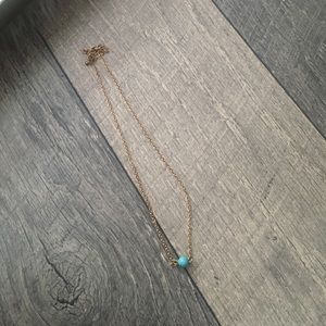 Necklace with a teal ball